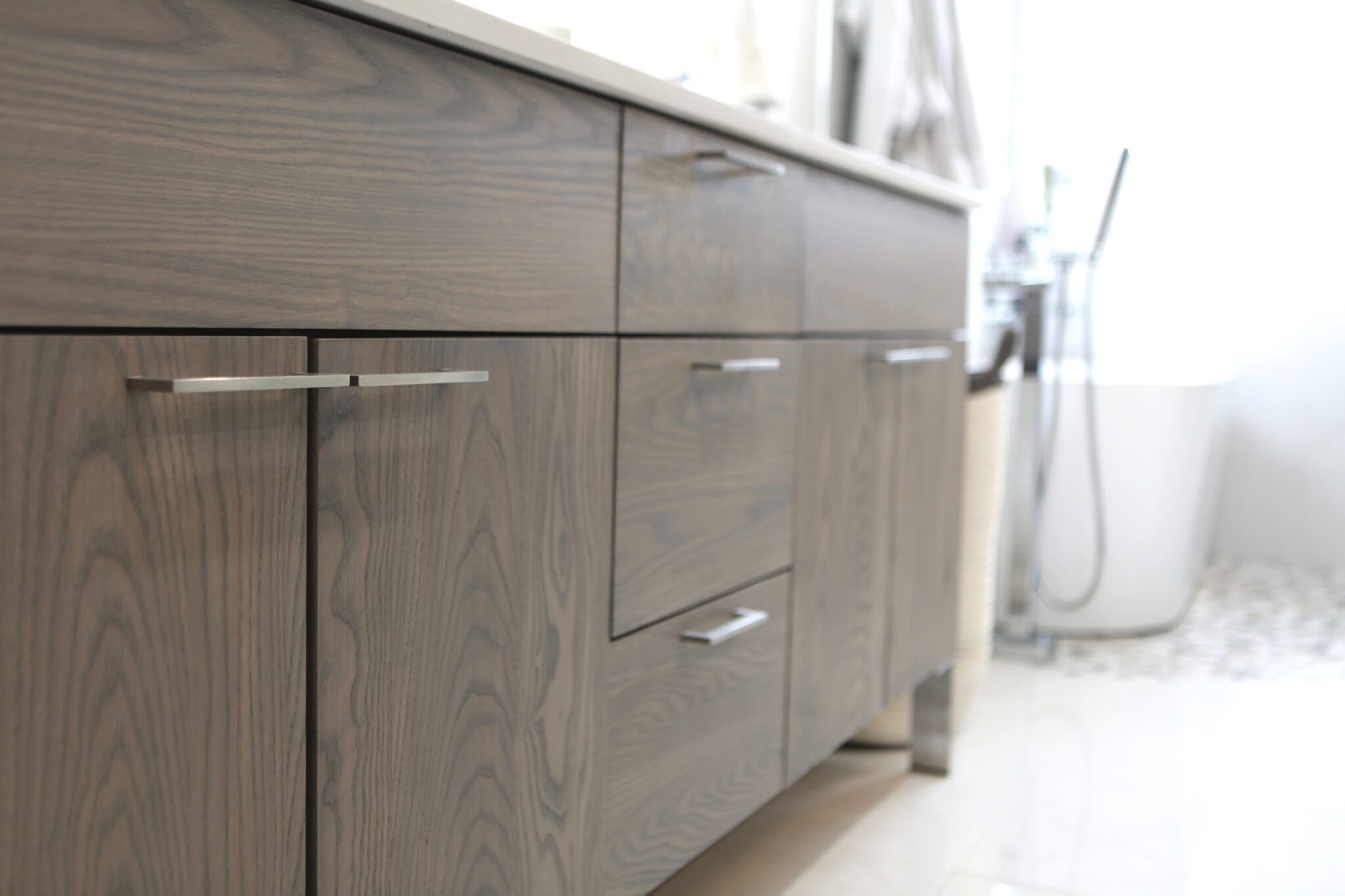Close-up of wood-textured bathroom vanity cabinets